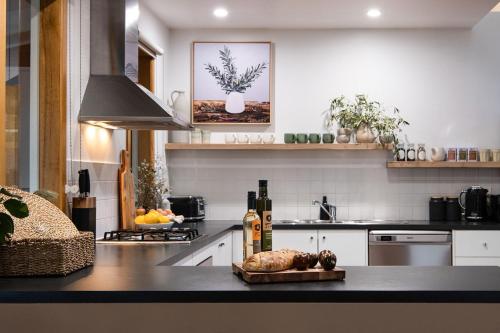 a kitchen with a table with a turkey on a counter at Kuca Stone in Daylesford