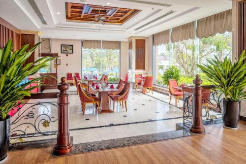 a dining room with a table and chairs at DLG Hotel Danang in Da Nang