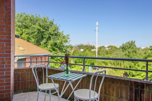 einen Tisch und zwei Stühle auf dem Balkon in der Unterkunft Bright one-bedroom in Villeneuve-d'Ascq - Welkeys in Villeneuve d'Ascq