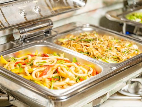 a metal tray filled with different types of food at DLG Hotel Danang in Da Nang