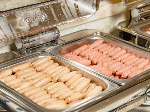 a tray of hot dogs and sausages at DLG Hotel Danang in Da Nang