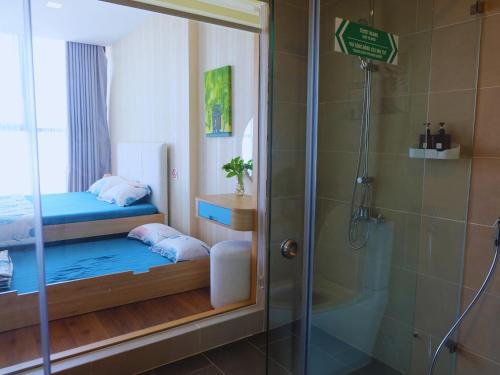 a bathroom with two beds and a shower at Little Cloud Home Vũng Tàu - CSJ Tower in Vung Tau