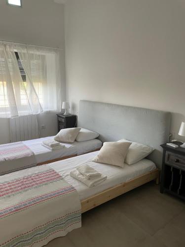 two beds sitting in a room with at El paller de L´Armentera 3 in Saldet