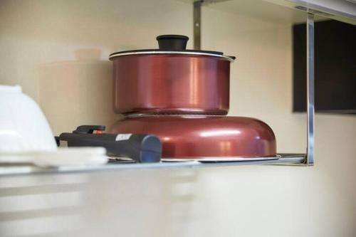 a pot on top of a stove in a kitchen at Oyado Kinokuniya Daikokumachi in Nagasaki