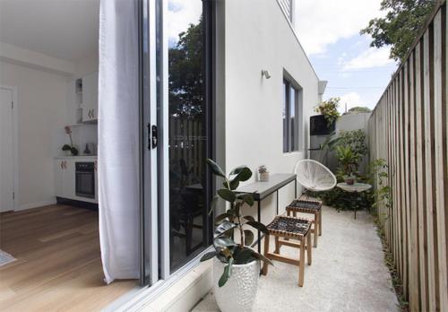 a balcony with chairs and a table on a building at Currumbin Beach 1 bedroom Studio - steps from the beach! in Gold Coast