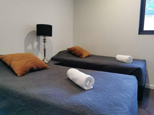 two beds in a room with towels on them at Orange Stay Sydney CBD in Sydney