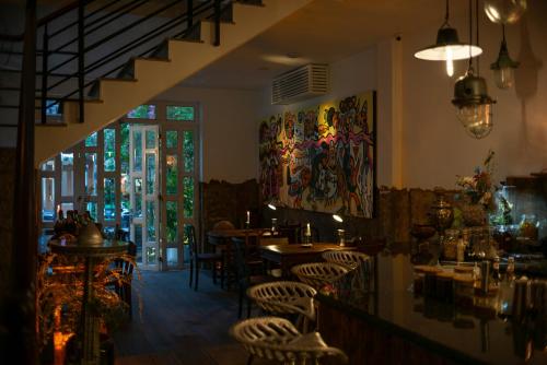 a restaurant with tables and chairs and a window at Amanaki Thao Dien in Ho Chi Minh City