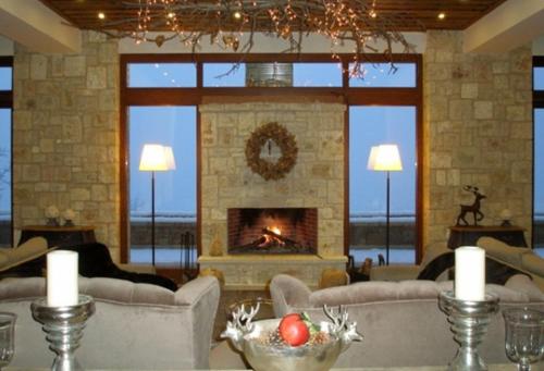 a living room with a fireplace and couches at Styga Mountain Resort in Zarouchla