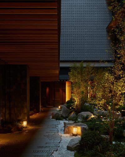 a garden with lights in front of a building at Dusit Thani Kyoto in Kyoto