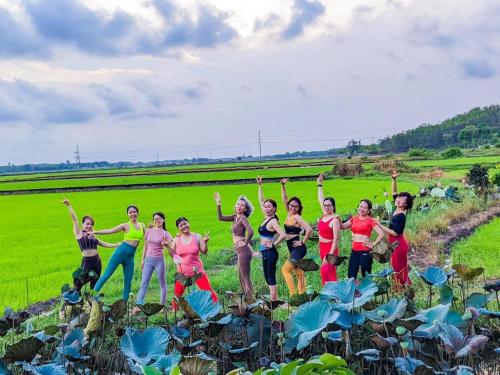 a group of people standing in a field at The Ruong Resort in Vung Tau