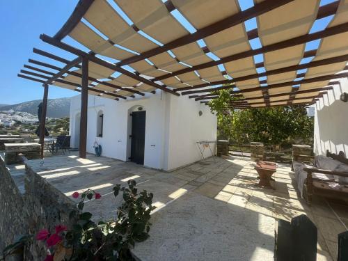a patio with a large wooden pergola at Apollon-Artemis Apartments in Apollonia
