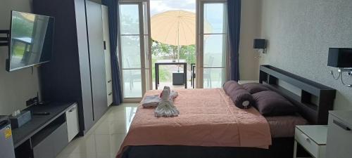 a bedroom with a large bed with a pink blanket at ganze Villa beachfront-pool-villa-Apartment in Ko Chang