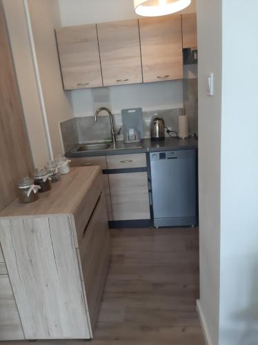 a kitchen with a sink and a counter top at Apartament Komfortowy - w pełni wyposażony - SpaceApart in Jelenia Góra