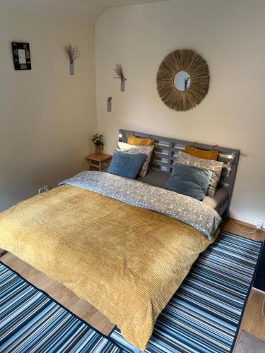 a bedroom with a large bed with blue pillows at Center studio hause in Kaunas