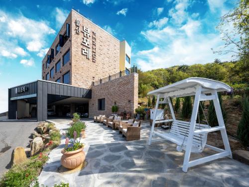 a white gazebo in front of a building at Yeosu View Foret Pension in Yeosu
