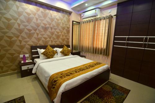 Ένα ή περισσότερα κρεβάτια σε δωμάτιο στο Tulip Residency - A Boutique Hotel