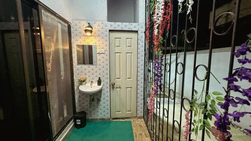 a bathroom with a sink and a white door at Mystic Dreamville 3BHK Villa Lonavala in Lonavala