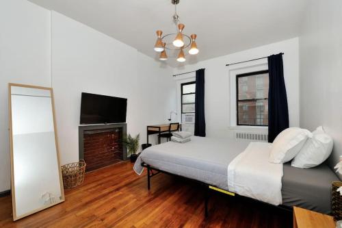 a bedroom with a large bed and a fireplace at Studio close to Times Square in New York