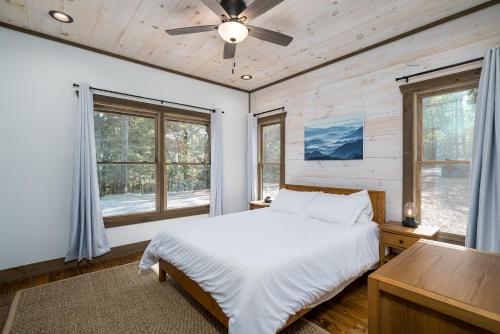 a bedroom with a bed and a ceiling fan at Peaceful Luxury Cabin, hot tub, games, 3 fireplaces in Blue Ridge