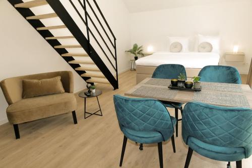 a room with a table and chairs and a bed at HVN10 - Near Antwerp in Stabroek