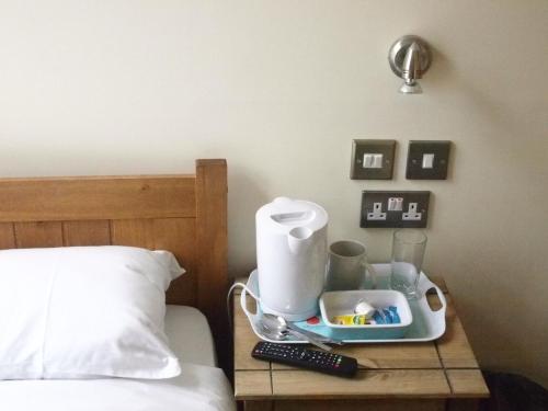 a tray on a table next to a bed at Earls Court Garden Hotel in London