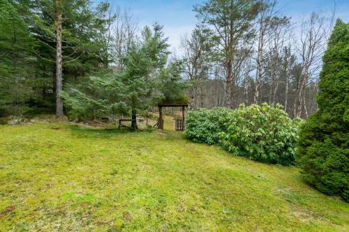 a gazebo in the middle of a field with trees at Fjord peace in Skodje