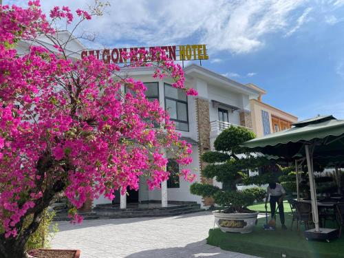 a building with pink flowers in front of it at Sai Gon Ha Tien Hotel in Hà Tiên