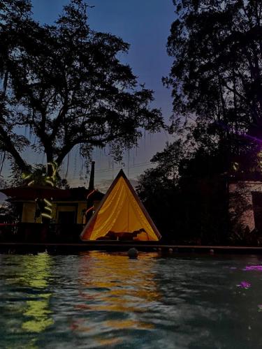 a tent on the side of a body of water at Don Fierro Hostal Campestre in Popayan