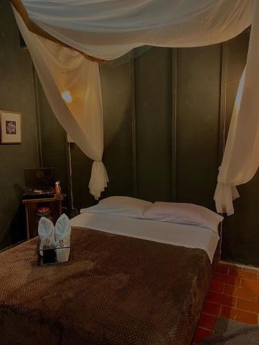 a bedroom with a bed with a canopy at Don Fierro Hostal Campestre in Popayan