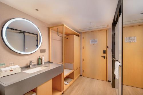 a bathroom with a sink and a mirror at Hilton Garden Inn Guangzhou Airport Aerotropolis - Free shuttle to Airport in Huadu