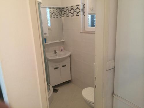 a bathroom with a toilet and a sink at Apartment Vesna in Supetar