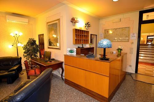 a living room with a couch and a desk at Hotel Amba Alagi in Marghera
