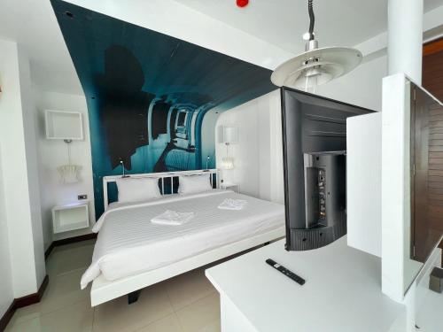 a bedroom with a bed with a fireplace in it at The Color Kata in Kata Beach