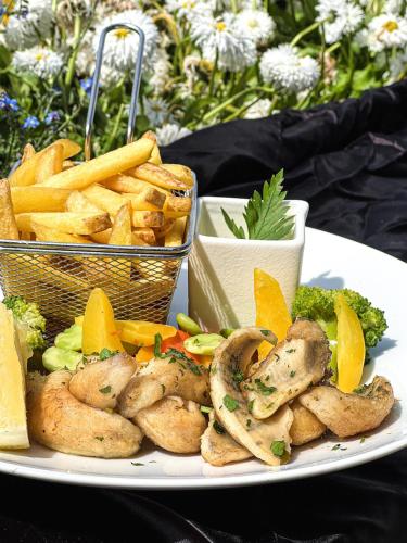 a plate of food with shrimp and french fries at Hotel Eden Palace au Lac in Montreux