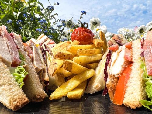 a group of sandwiches and french fries on a table at Hotel Eden Palace au Lac in Montreux