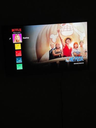 a television screen with a picture of a group of people at Habitación VIP in Ibagué
