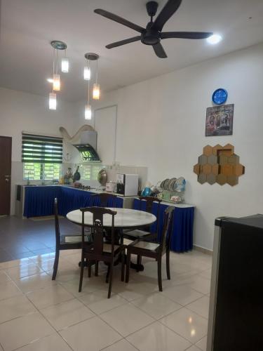 a dining room with a table and chairs at D'tasek Homestay Gua Musang in Gua Musang