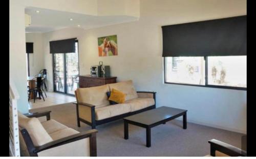 a living room with a couch and a table at the Ningaloo breeze villa 2/10 in Exmouth