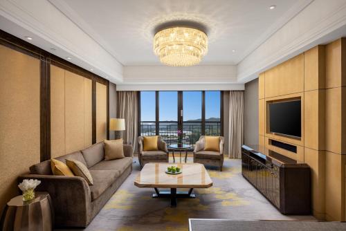 a living room with a couch and a tv at Midtown Shangri-La, Hangzhou - around 5 minutes walking distance to West Lake in Hangzhou