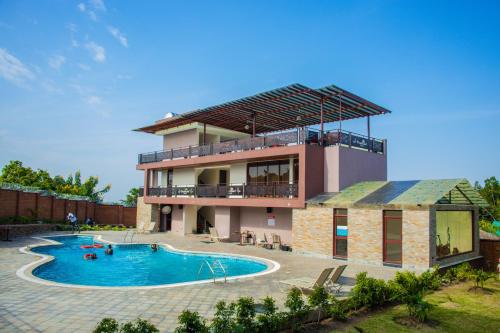 a house with a swimming pool in front of it at Dreamland Hotel in Arua