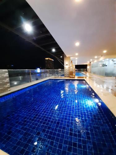 a swimming pool on top of a building at night at 1809 Sunvida Tower Condo across SM City Cebu in Cebu City