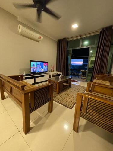 a living room with a couch and a flat screen tv at Harmoni Homes Vista Alam in Shah Alam