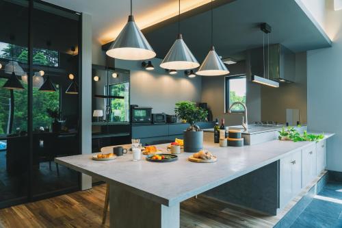 a kitchen with a large island with food on it at サウナ付き大人の隠れ家 -Kito NASU- in Nasu