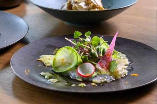 a plate with a dish of food on a table at Hotel Indigo Karuizawa in Karuizawa