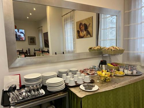 a kitchen counter with plates and bowls of food at Cà Dei Barcaroli in Mestre