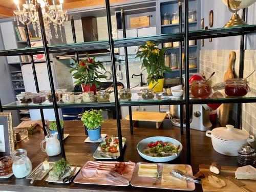 a table with plates of food on top at VILLA OXA - Boutique Design Hotel in Maria Alm am Steinernen Meer