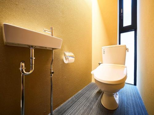 a bathroom with a toilet and a sink at 枳殻の杜 Kikoku no mori in Kyoto