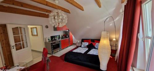 a living room with a black couch and a red rug at Am alten Siel in Wilhelmshaven