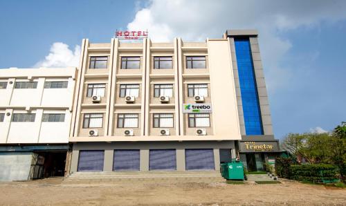 a building with a sign on top of it at Treebo Trend Trinetar International in Jammu