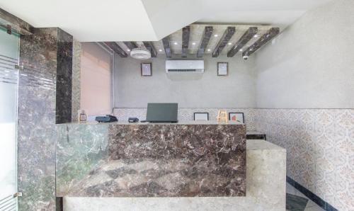 a room with a shower with a laptop on a counter at Treebo Trinetar International in Jammu